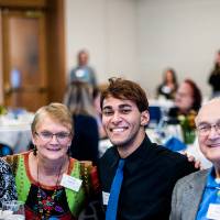 A student sitting with his donors.